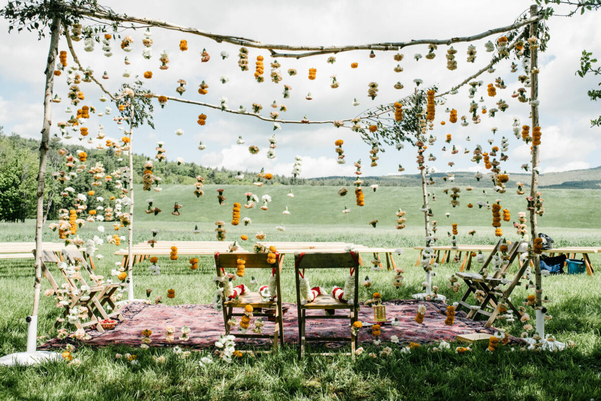 a wedding ceremony setup with hanging flowers