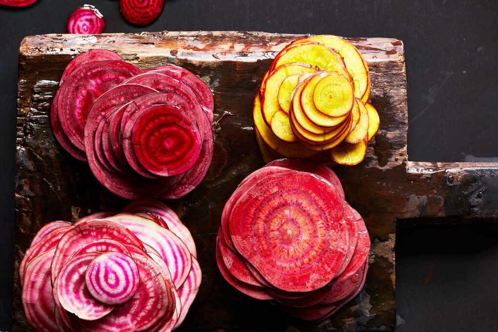 multicolor sliced radishes on a wooden block