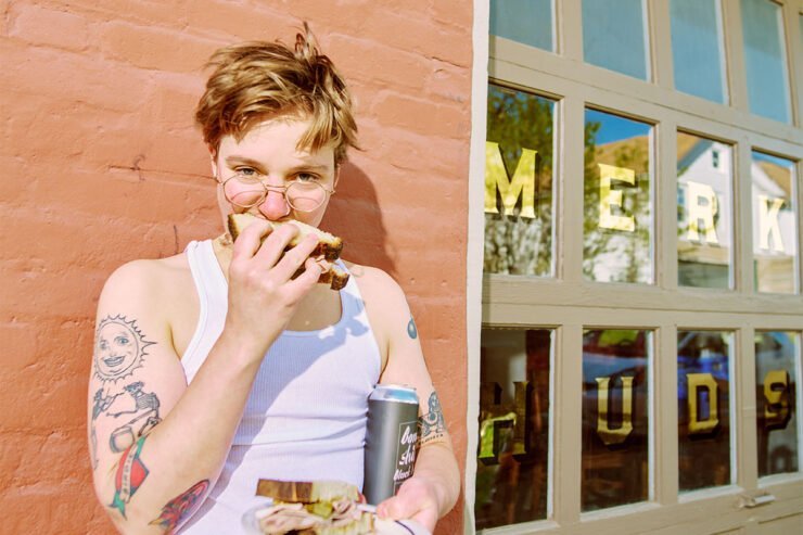 Shaina Loew-Banayan eats a sandwich outside of Merkin Hudson